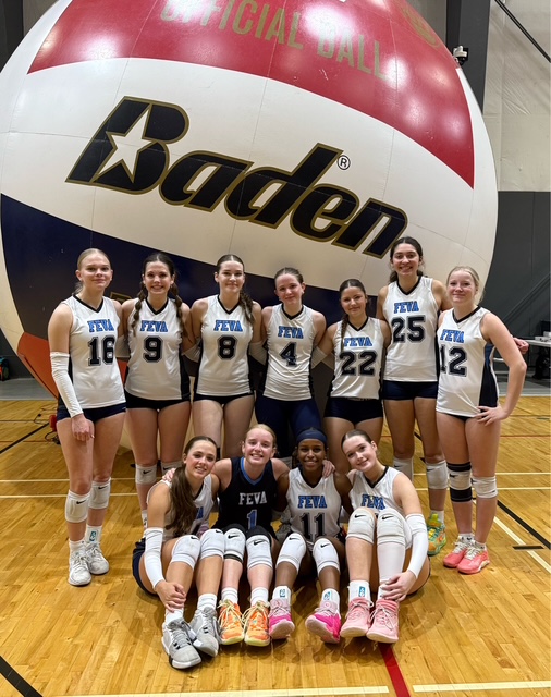 The FEVA U16 volleyball team poses for a group photo in front of a large Baden volleyball in a gymnasium.