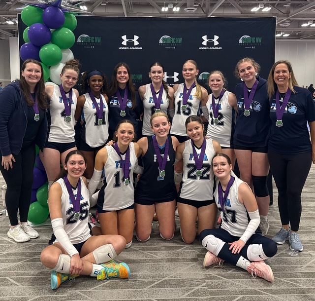 The FEVA U16 volleyball team poses together with medals after competing in the Emerald City Classic tournament.