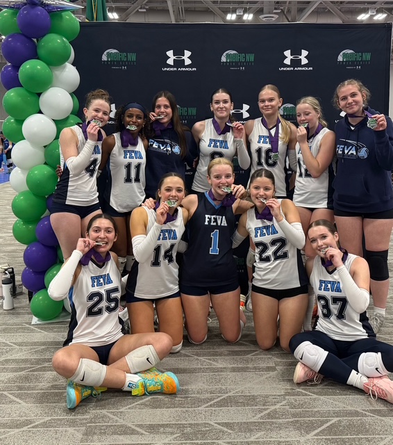 FEVA U16 volleyball team celebrating with medals after the Emerald City Classic. The team poses together, showcasing their achievements and team spirit.