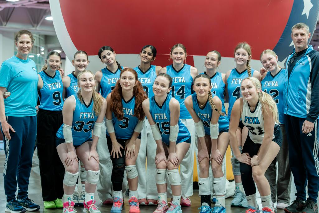 Group photo of FEVA's U15 volleyball team posing together at the Salt Lake City Showdown National Qualifier, with coaches and players in blue and white uniforms.