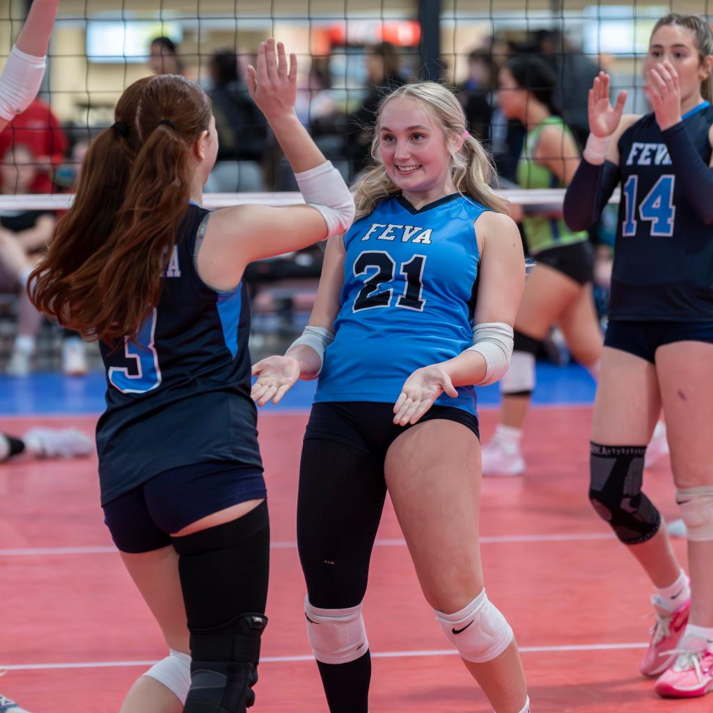 FEVA U15 volleyball players celebrating a point during a match at the Salt Lake City Showdown National Qualifier.